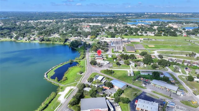 an aerial view of residential houses with outdoor space and lake view