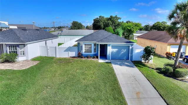 a front view of a house with a garden and plants