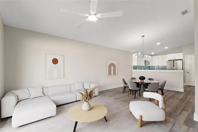 a living room with furniture and kitchen view