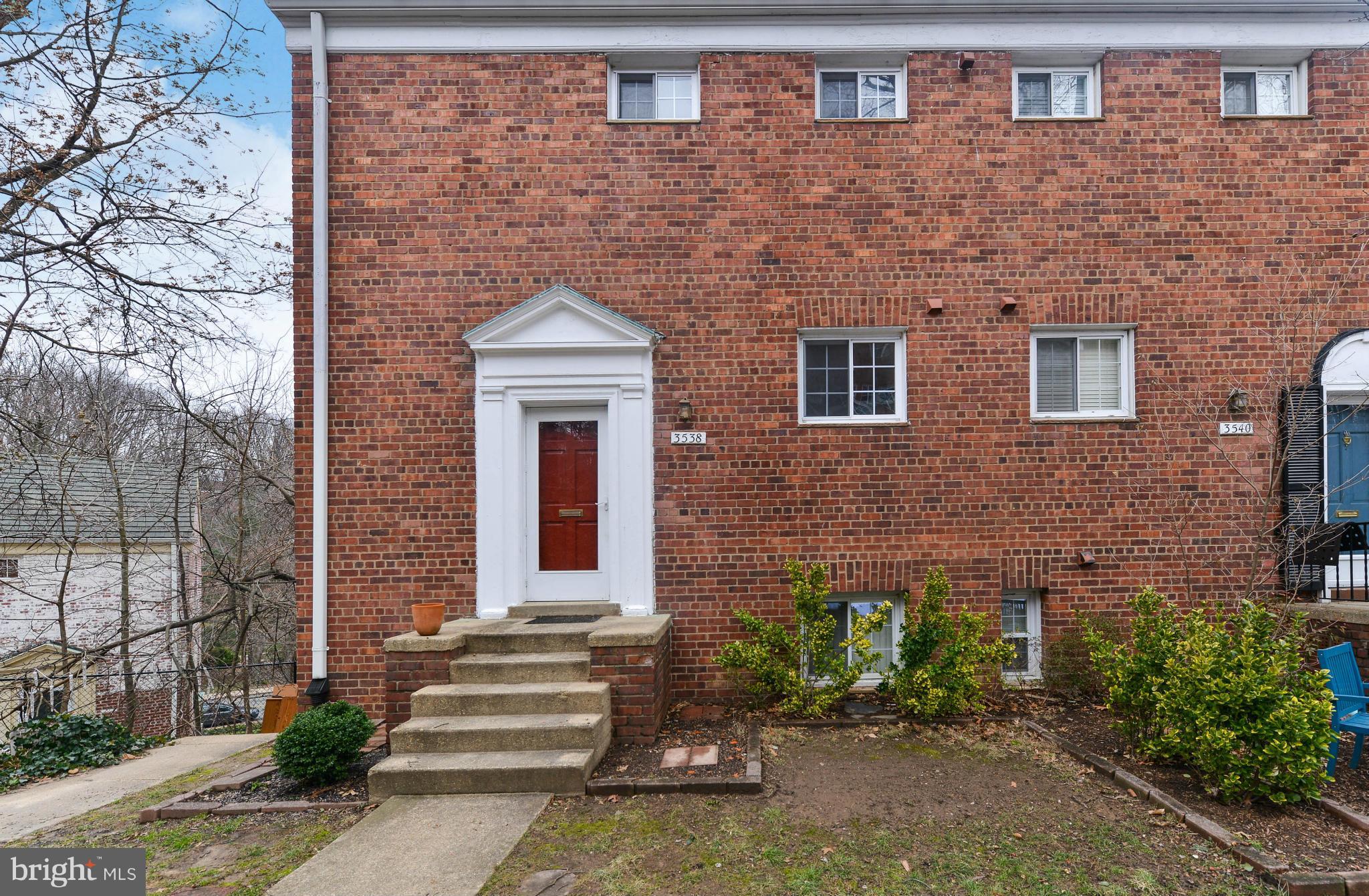 a front view of a house with a garden