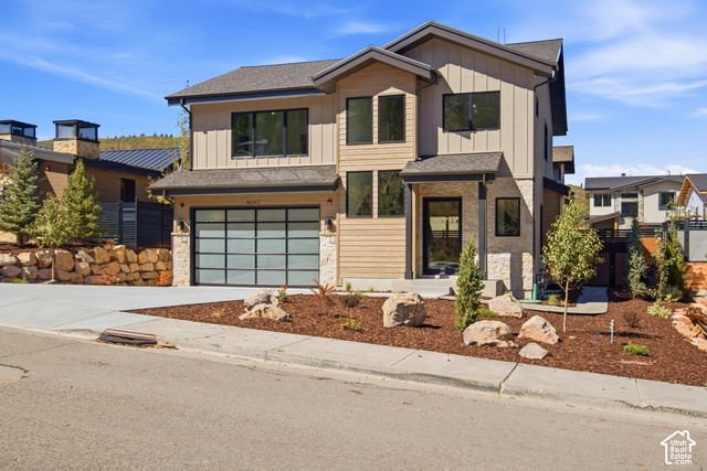 4092 Discovery Way Park City, UT 84098 - Photo 3 of 66 Contemporary exterior featuring vertical and horizontal siding, stone accents, a modern garage door, and a covered entry