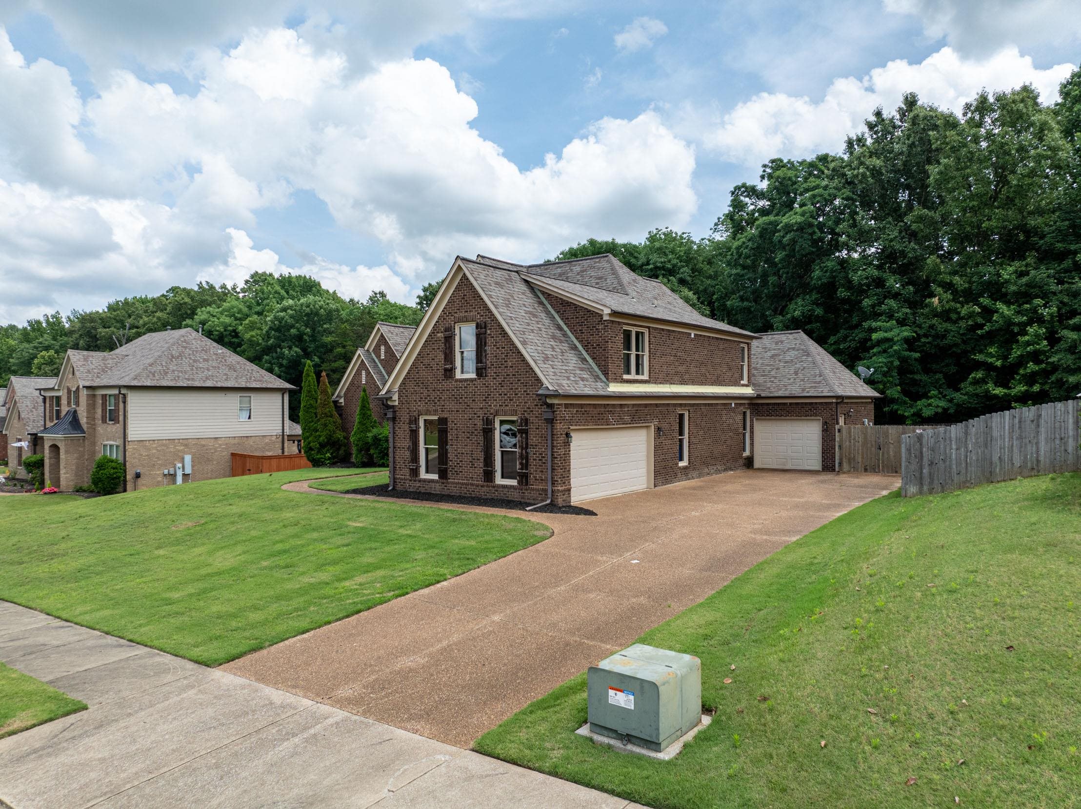 5380 Scarlet Ridge Drive Arlington, TN 38002 - Photo 2 of 35 Brick exterior with multiple gables, shuttered windows, and an attached two-car garage