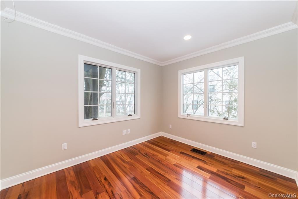 1 Elizabeth Road New Rochelle, NY 10804 - Photo 19 of 23 Empty room featuring baseboards, wood finished floors, crown molding, and recessed lighting
