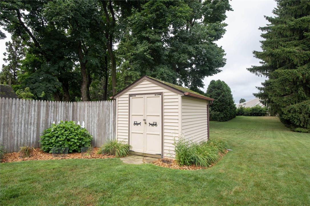 706 Stones Crossing Road Easton, PA 18045 - Photo 34 of 40 Another view into the large manicured yard featuring a picket fence, lush lawn, and convenient storage shed.