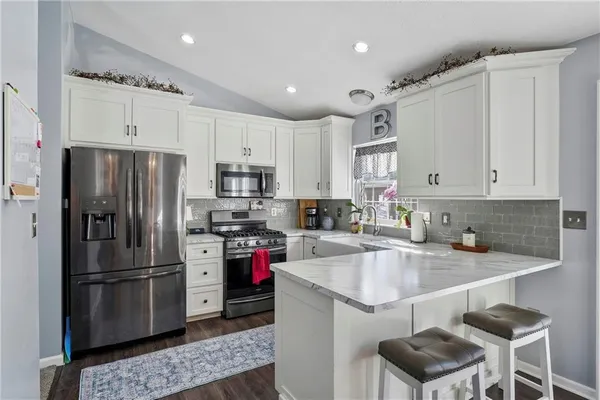 a kitchen with a sink stainless steel appliances and cabinets