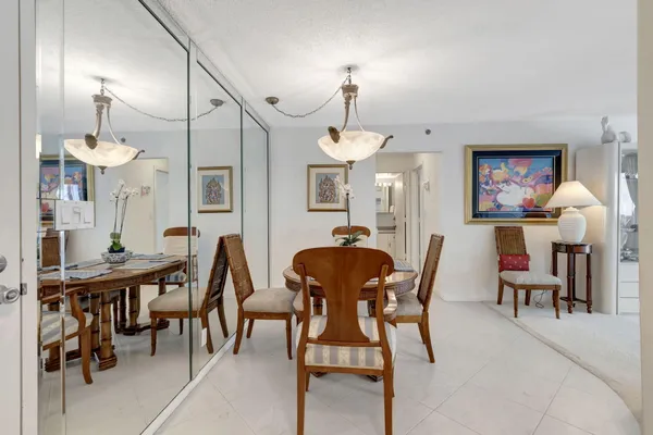 a living room with furniture a rug and a wall painting