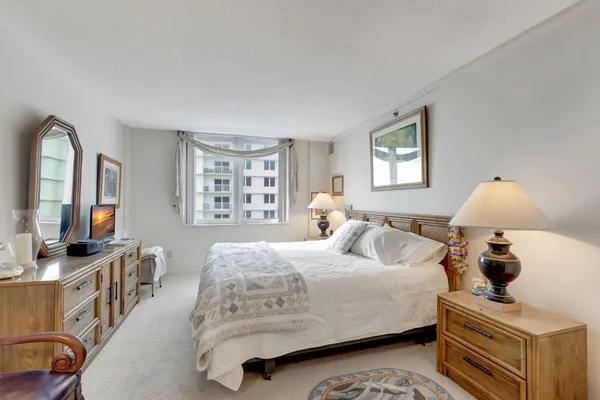 a bedroom with furniture and a flat screen tv