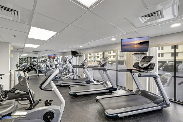 a room with pool table and windows