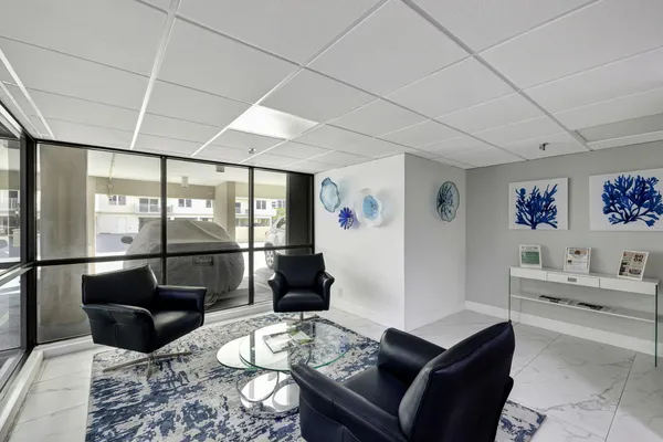a view of a hallway with wooden floor and a bathroom