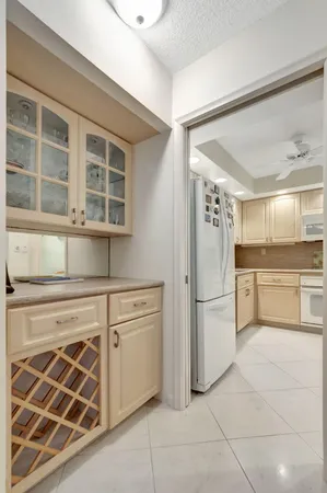 a kitchen with stainless steel appliances granite countertop white cabinets and a sink