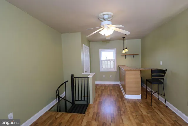 a view of a room with wooden floor windows and a chandelier