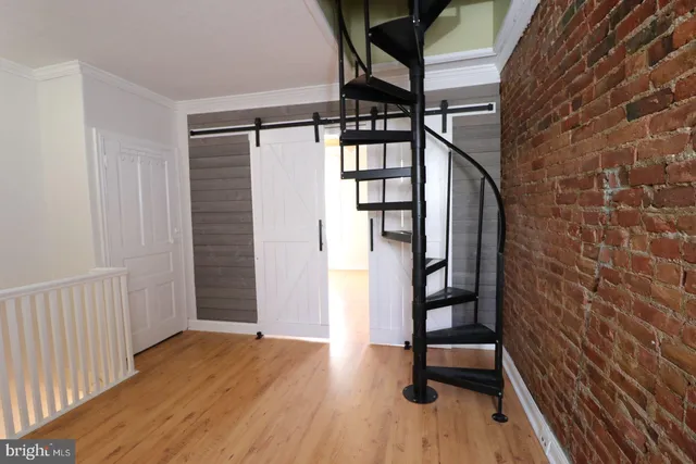 a view of entryway with stairs and wooden floor