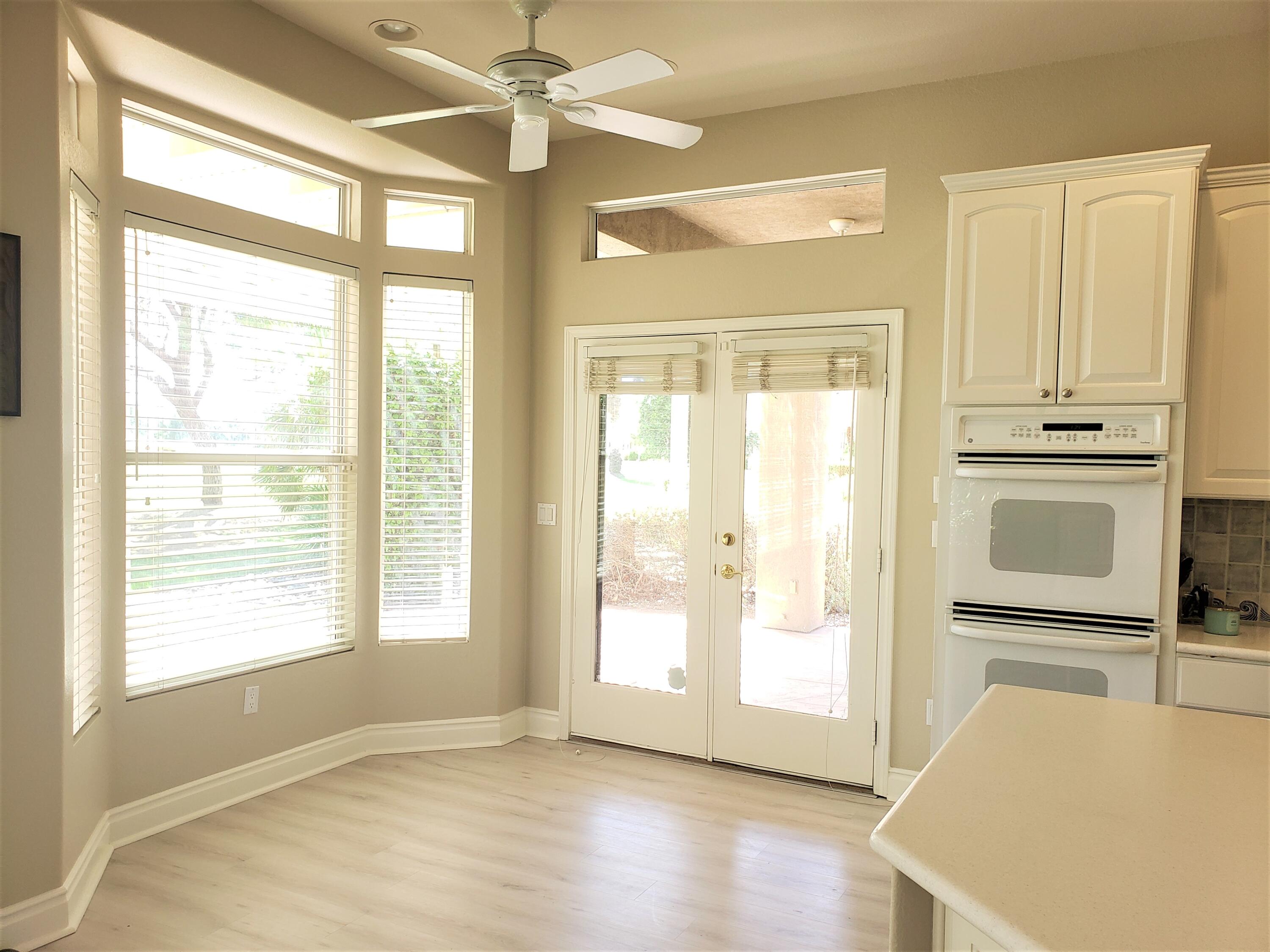 44017 Royal Troon Drive Indio, CA 92201 - Photo 15 of 33 a view of an empty room with a window and wooden floor