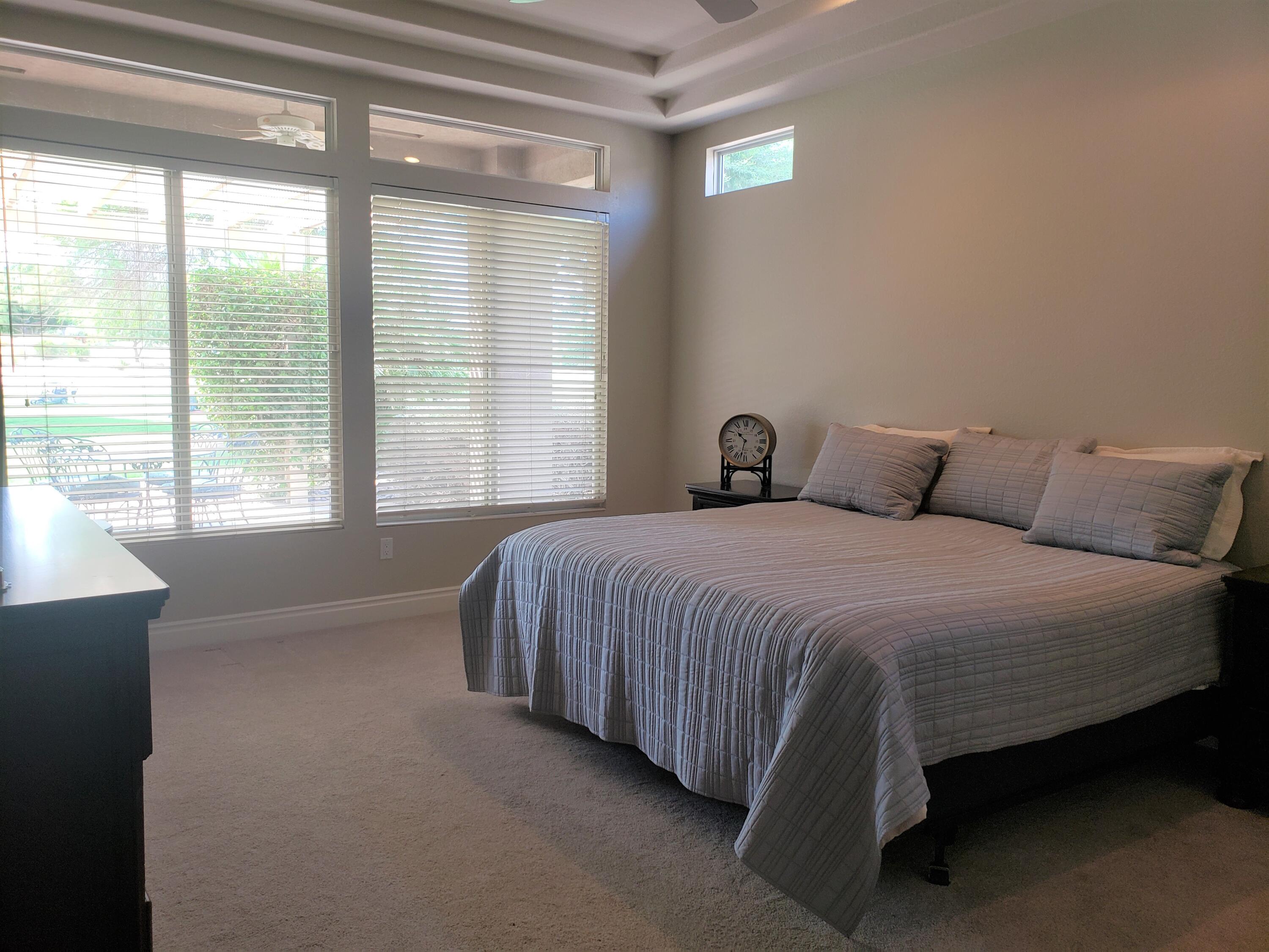 44017 Royal Troon Drive Indio, CA 92201 - Photo 17 of 33 a bedroom with a bed and window