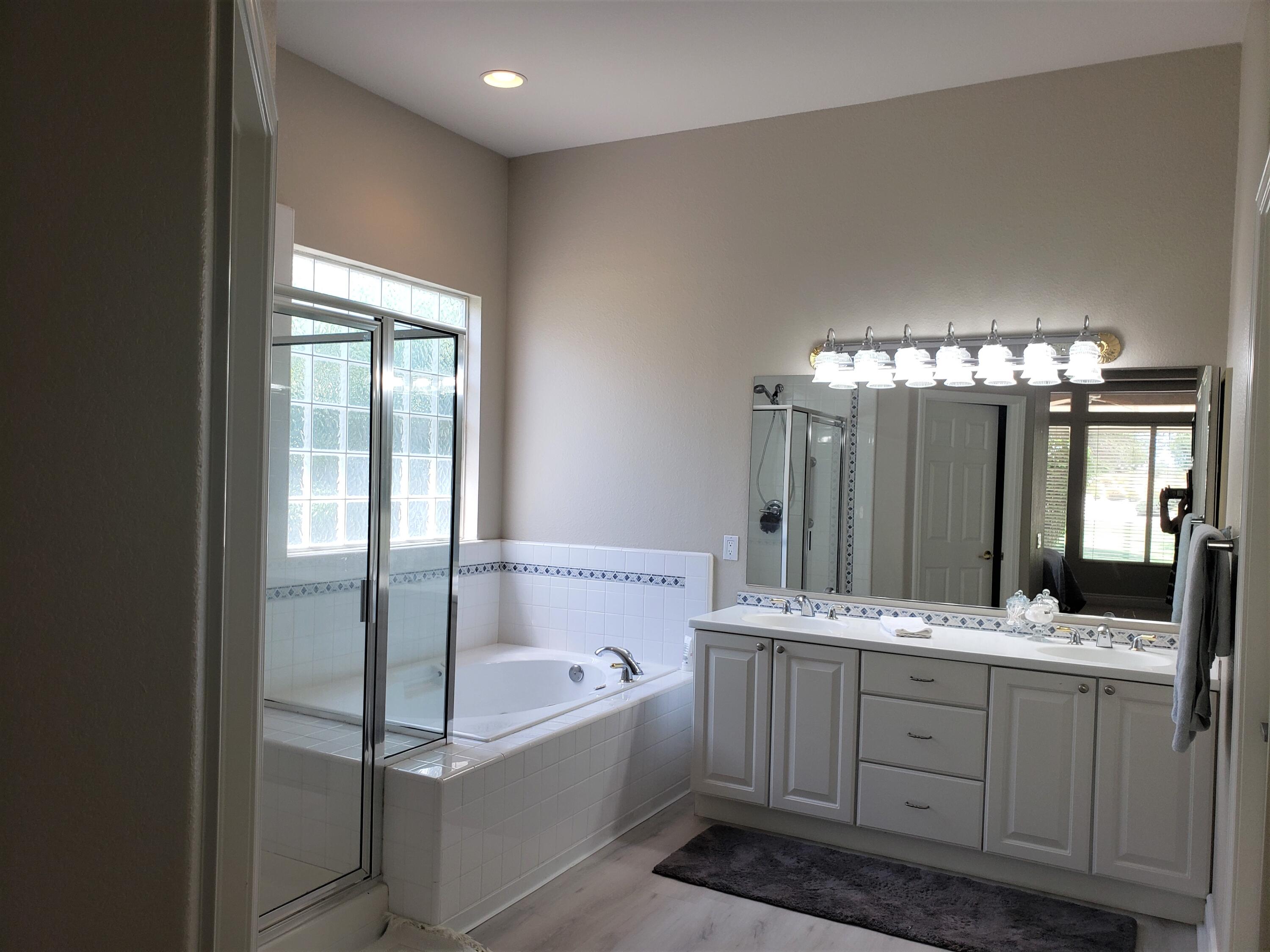 44017 Royal Troon Drive Indio, CA 92201 - Photo 21 of 33 a bathroom with a double vanity sink mirror and bathtub