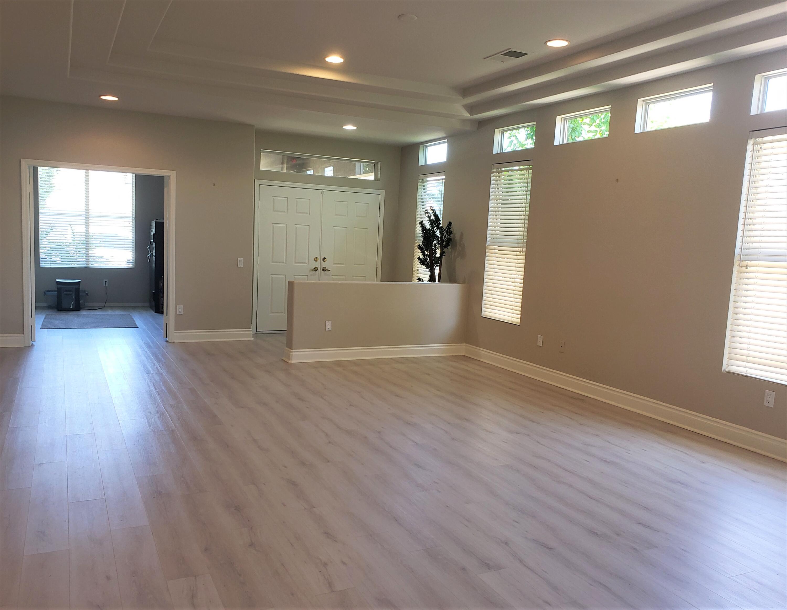 44017 Royal Troon Drive Indio, CA 92201 - Photo 5 of 33 an empty room with wooden floor and windows