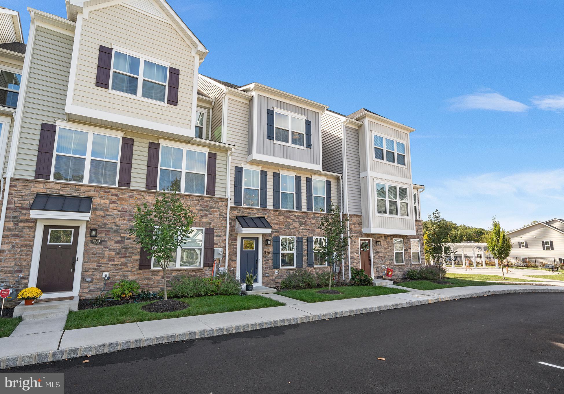 a front view of a residential apartment building with a yard