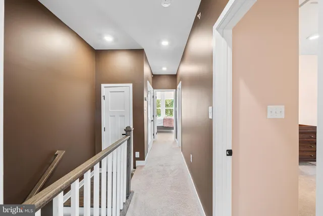 a bedroom with a bed and a flat tv screen on dresser