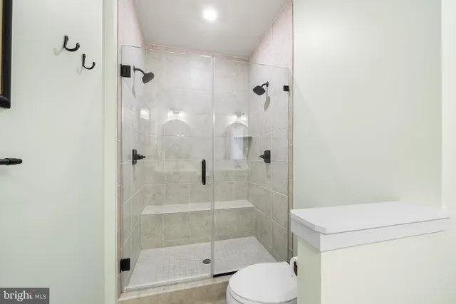 a living room with furniture a baby crib and a window