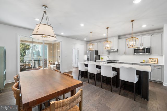 a large kitchen with a table and chairs