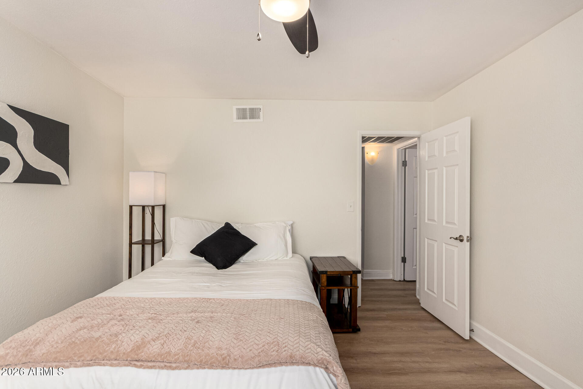 5877 North Granite Reef Road, Unit 1133 Scottsdale, AZ 85250 - Photo 16 of 33 a bedroom with a bed and a chandelier