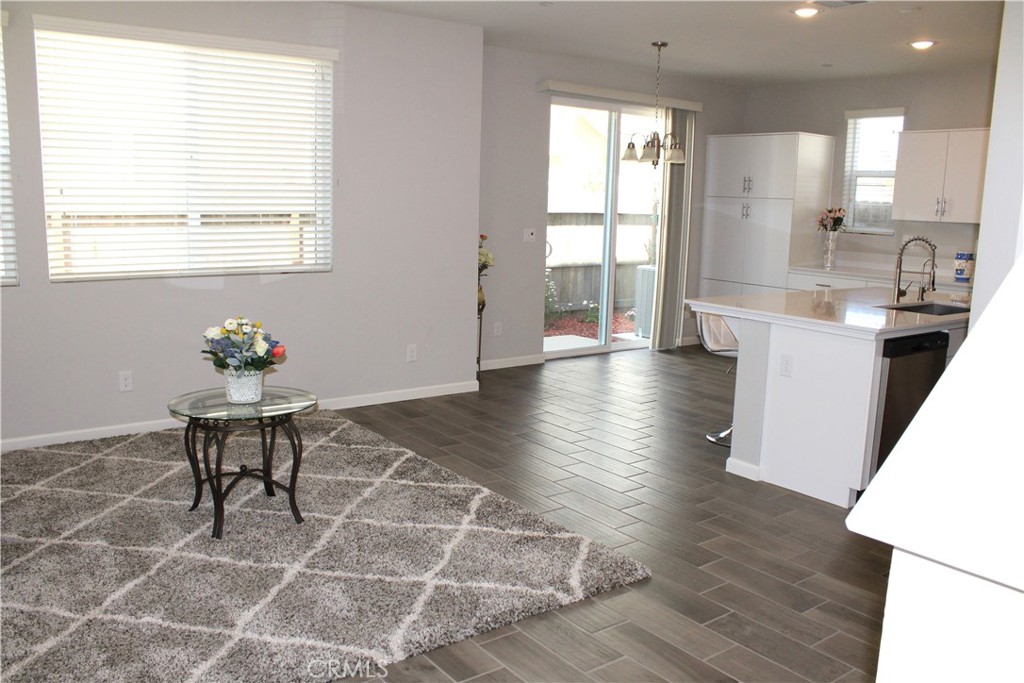 2060 North Walker Lane Clovis, CA 93619 - Photo 4 of 17 a dining hall with granite countertop a dining table chairs and a refrigerator