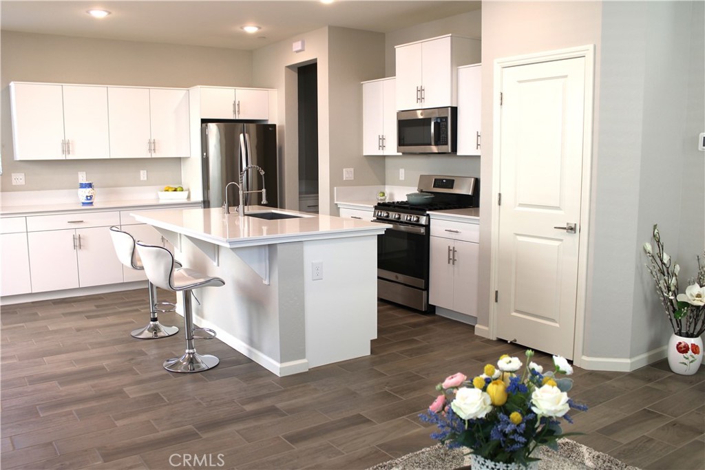2060 North Walker Lane Clovis, CA 93619 - Photo 5 of 17 a kitchen with stainless steel appliances a stove refrigerator sink and microwave