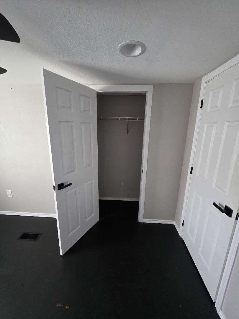 310 Paddock Street, Unit 4 Willis, TX 77378 - Photo 11 of 14 an empty room with wooden floor and cabinet