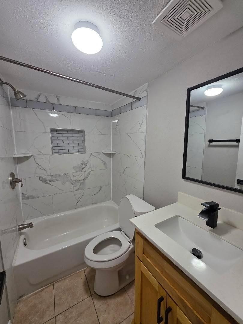 310 Paddock Street, Unit 4 Willis, TX 77378 - Photo 12 of 14 a bathroom with a sink a toilet and shower