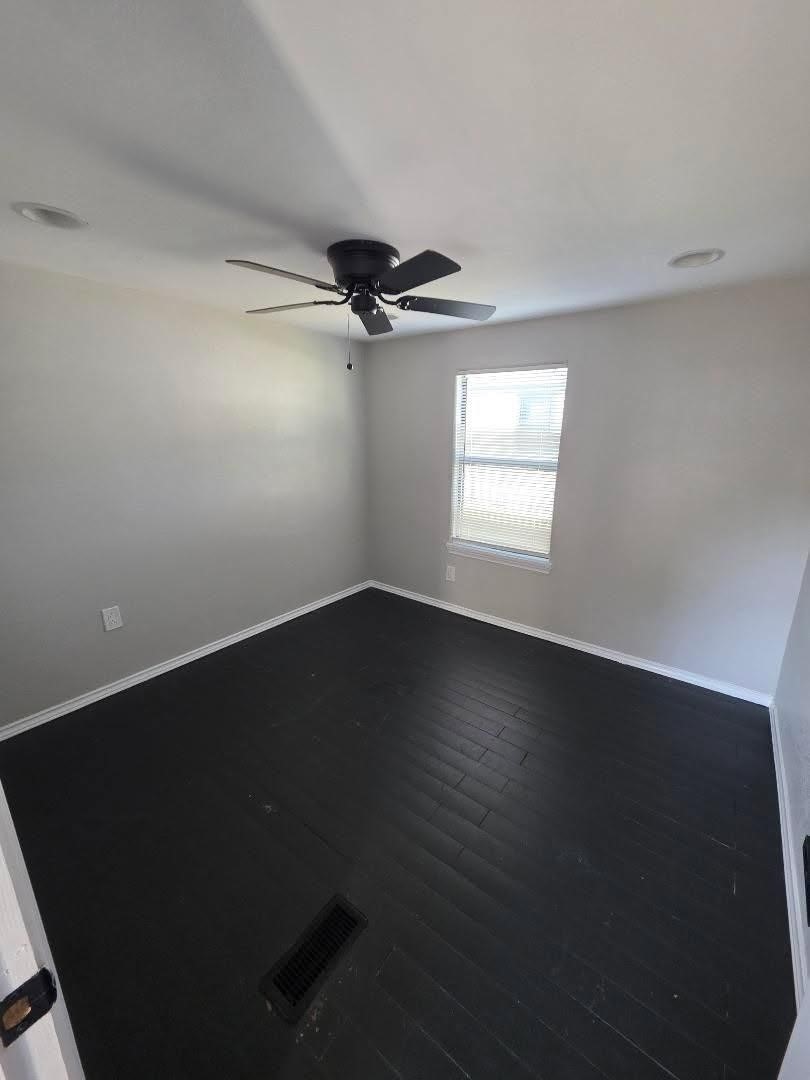 310 Paddock Street, Unit 4 Willis, TX 77378 - Photo 13 of 14 a view of an empty room with wooden floor and a window