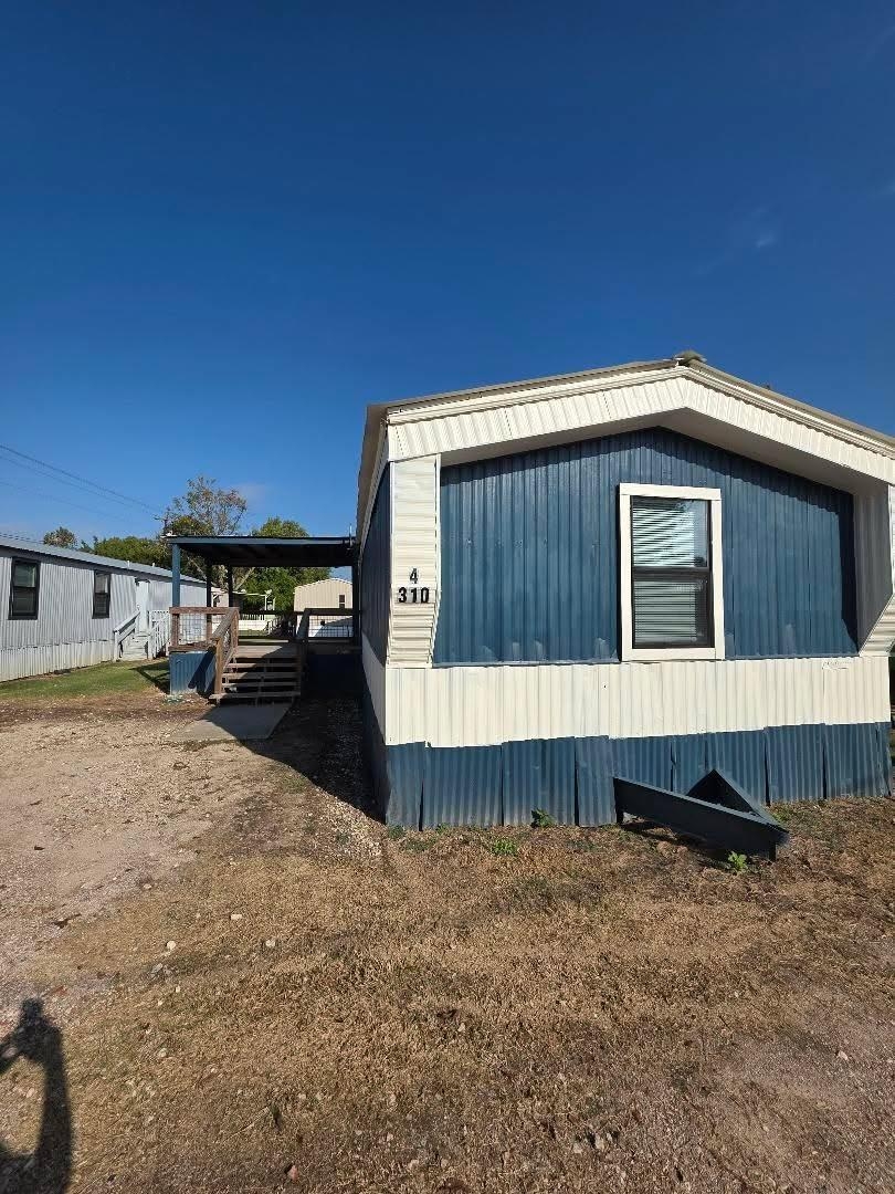 310 Paddock Street, Unit 4 Willis, TX 77378 - Photo 2 of 14 a front view of a house with a yard