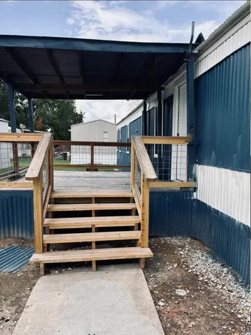 an empty room with windows and ceiling fan