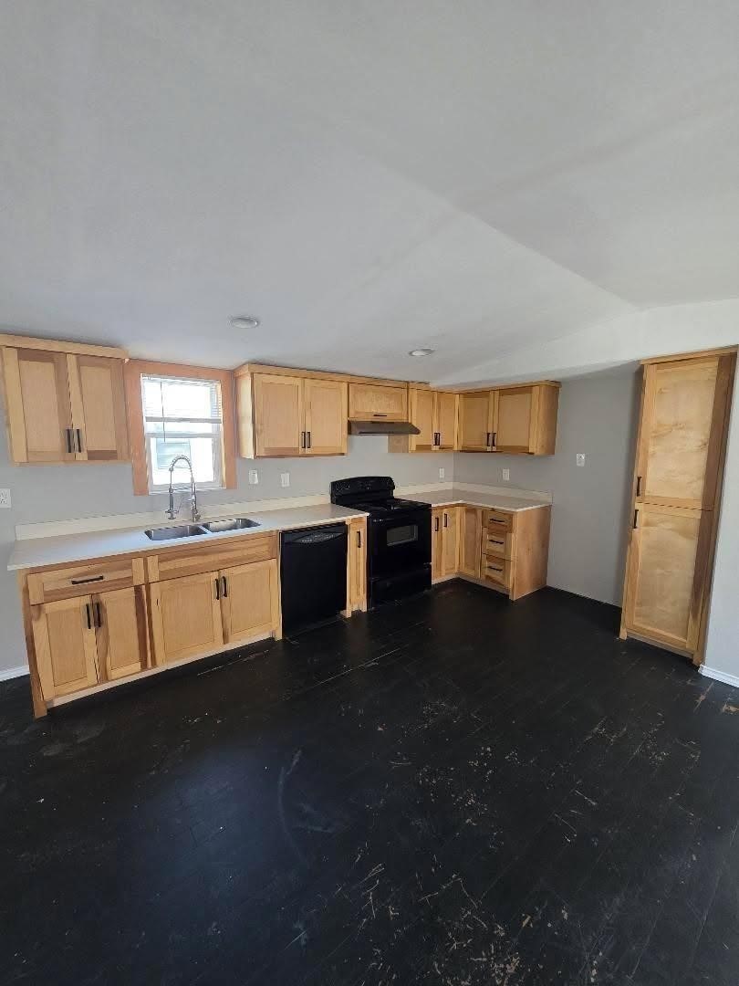 310 Paddock Street, Unit 4 Willis, TX 77378 - Photo 5 of 14 a kitchen with stainless steel appliances granite countertop a sink dishwasher stove and white cabinets with wooden floor
