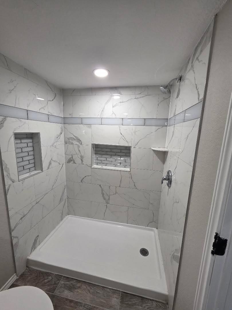 310 Paddock Street, Unit 4 Willis, TX 77378 - Photo 8 of 14 a bathroom with a tub and a shower