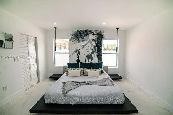 a bedroom with a bed and a window