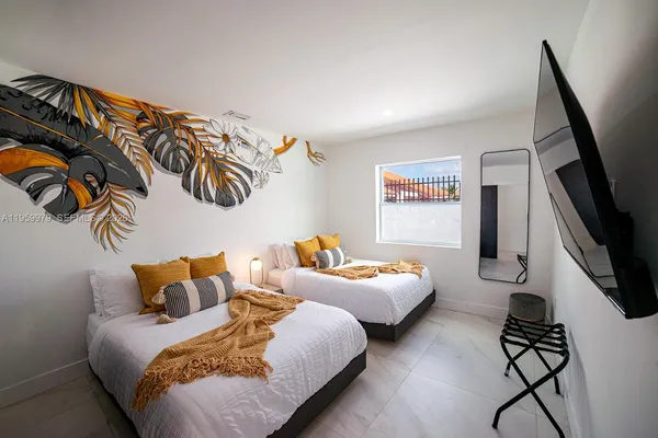 a bedroom with furniture and a flat screen tv