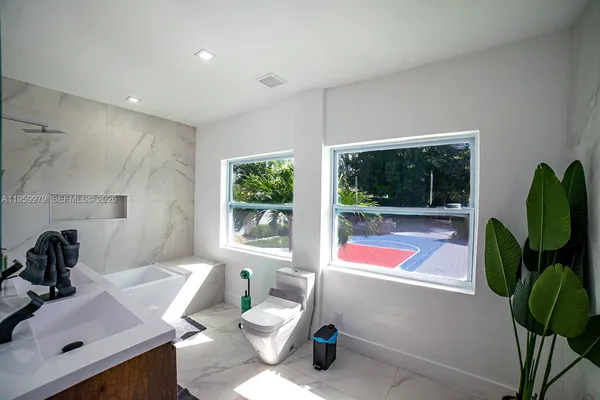 a bathroom with a sink mirror vanity and toilet