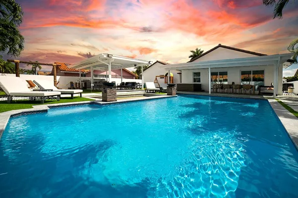 a view of a house with pool porch and a yard