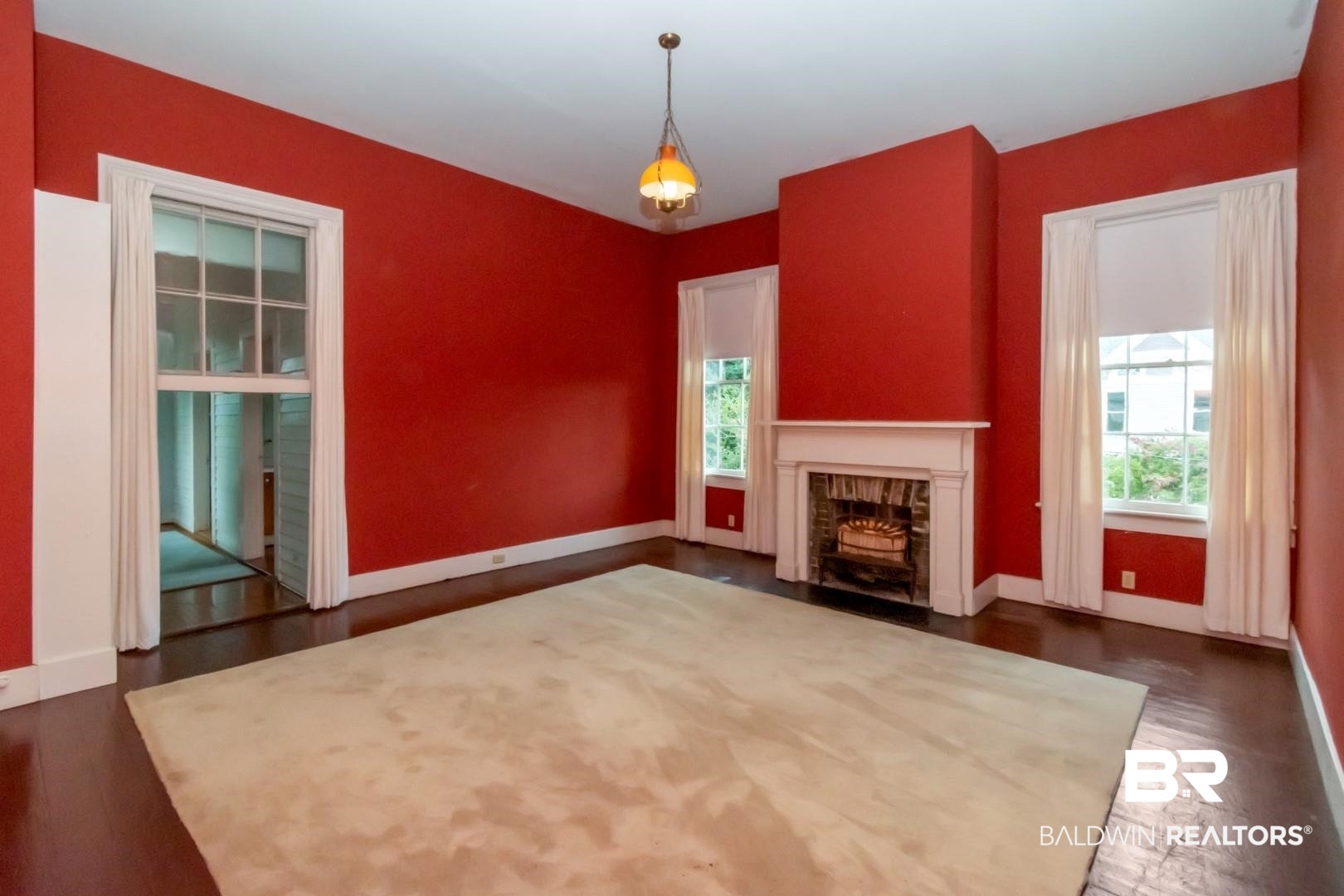 959 Dauphin Street Mobile, AL 36604 - Photo 28 of 43 Unfurnished living room featuring a fireplace and dark wood-type flooring