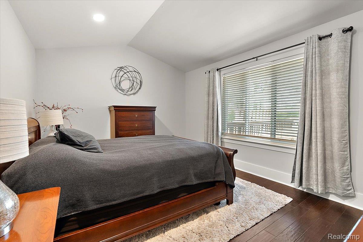 552 Tennyson Rochester, MI 48307 - Photo 16 of 36 Spacious bedroom featuring wood-finish flooring, a large window with blinds and drapes, and a recessed ceiling light
