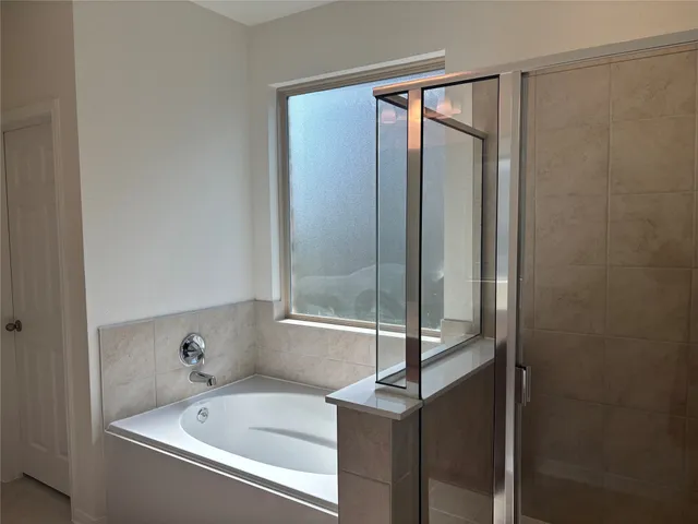 a bathroom with a bathtub and shower