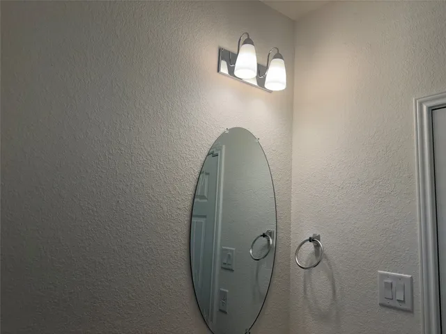 an empty room with wooden floor and mirror