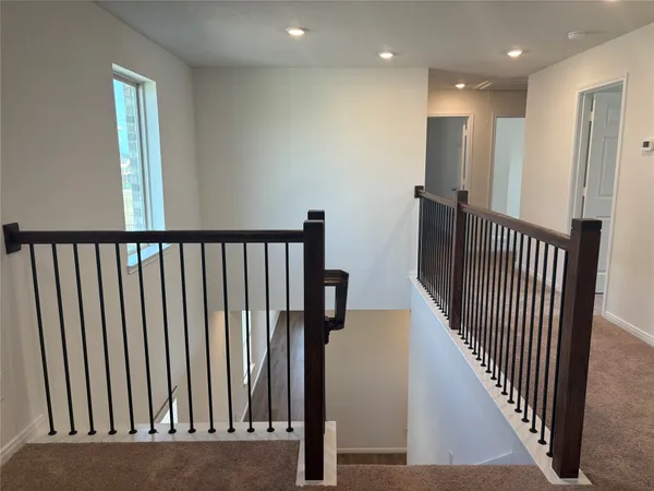 a view of a hallway with entryway door