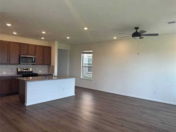 a kitchen with stainless steel appliances a refrigerator sink and microwave