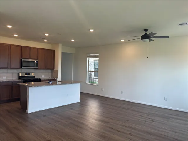 a kitchen with stainless steel appliances a refrigerator sink and microwave