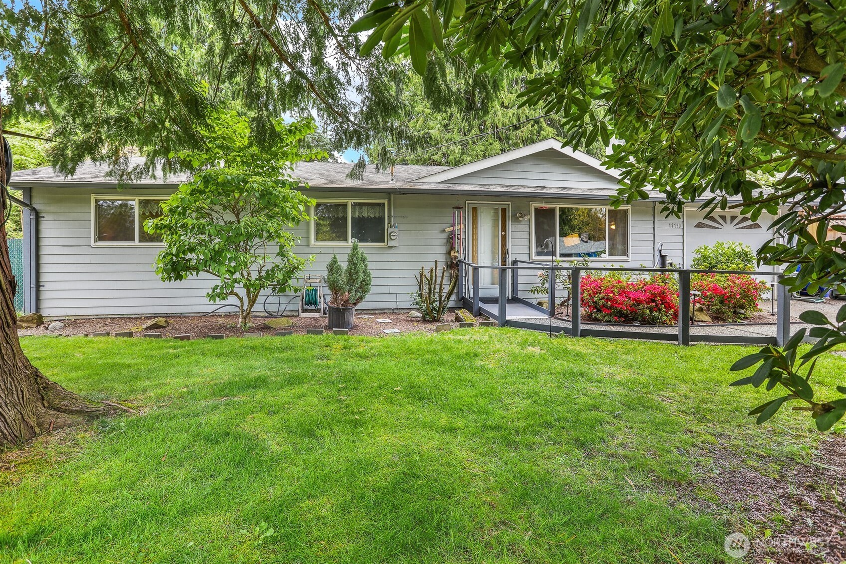 a front view of house with yard and outdoor seating