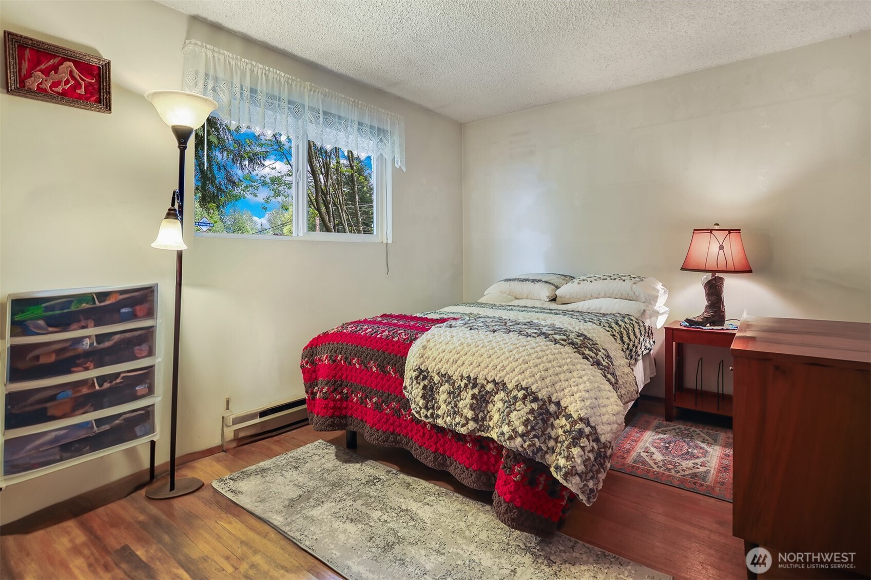 11120 3rd Place Southeast Everett, WA 98208 - Photo 27 of 35 a bedroom with a bed and a lamp on dresser
