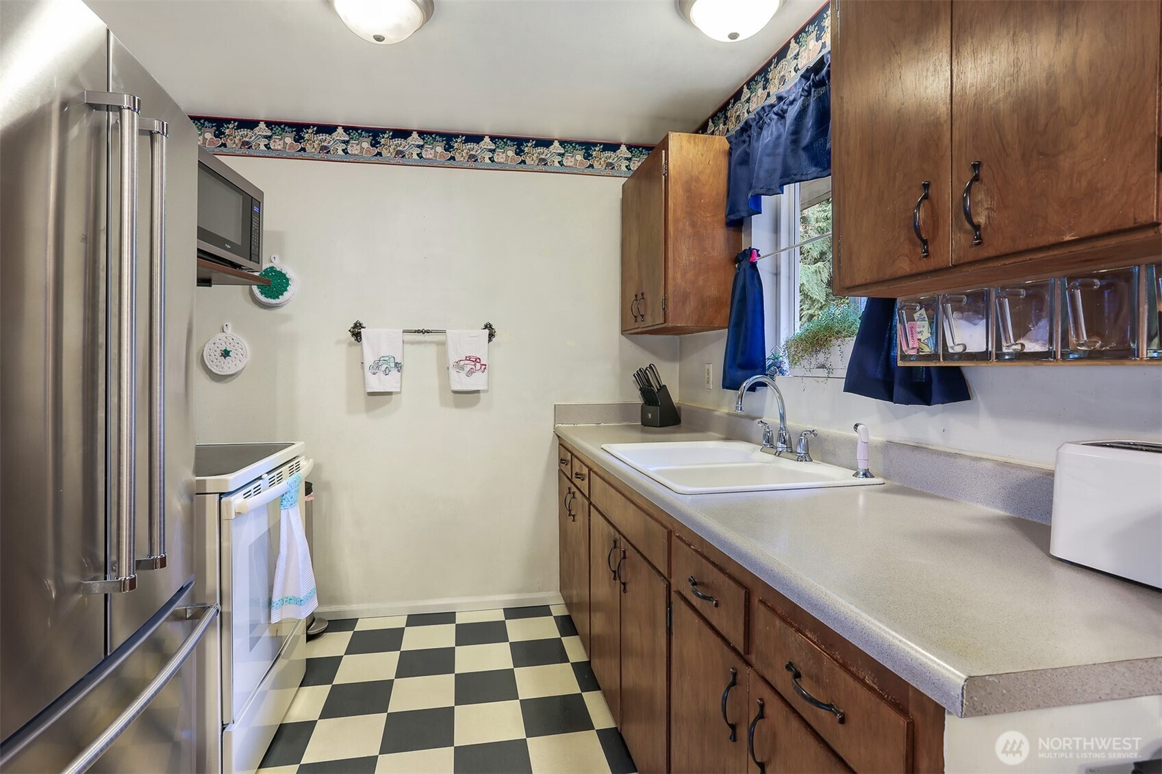 11120 3rd Place Southeast Everett, WA 98208 - Photo 7 of 35 a kitchen with a sink a refrigerator and cabinets