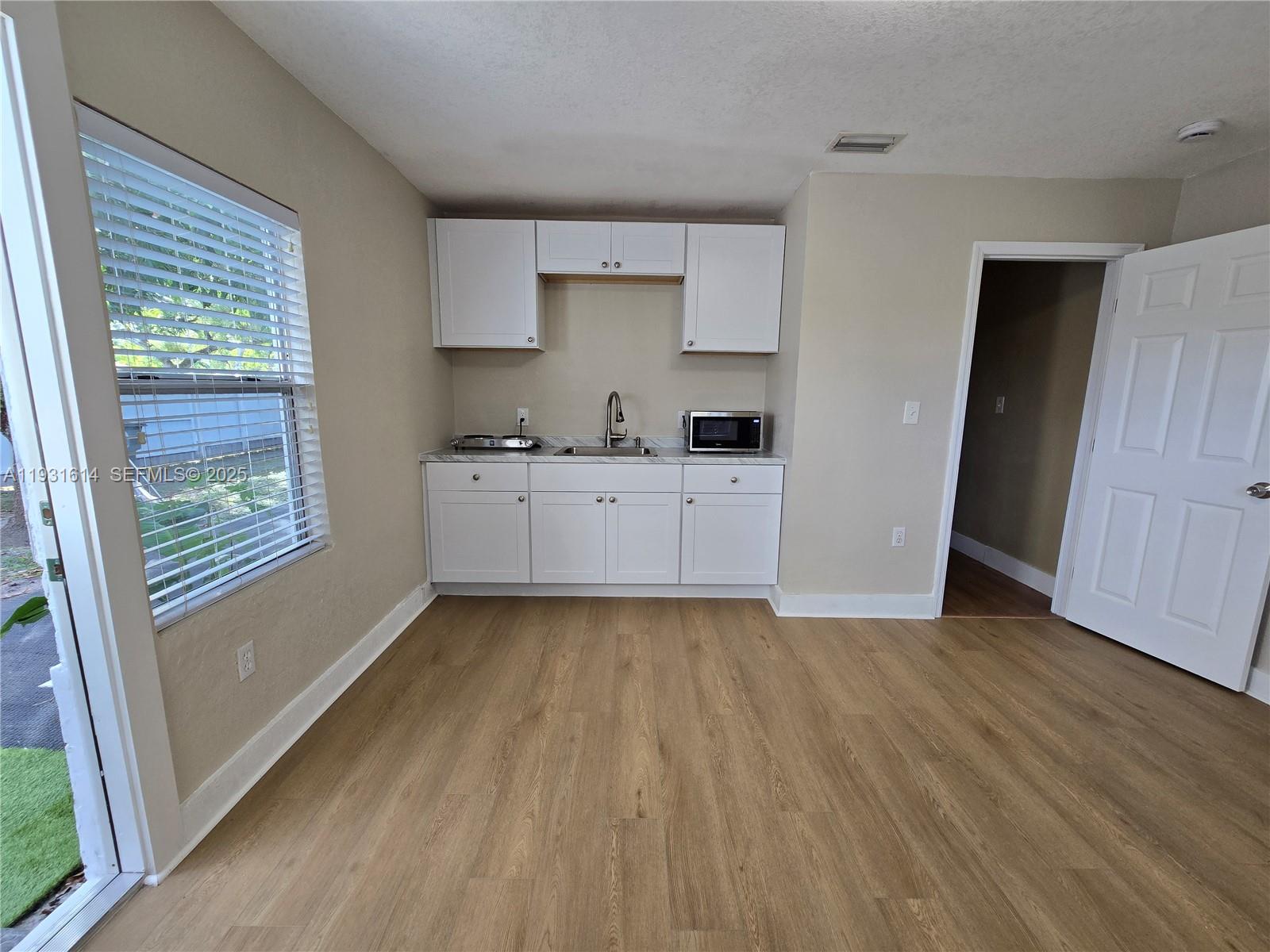 13340 Northeast 16th Avenue North Miami, FL 33161 - Photo 11 of 18 a kitchen with granite countertop a stove a sink and a refrigerator