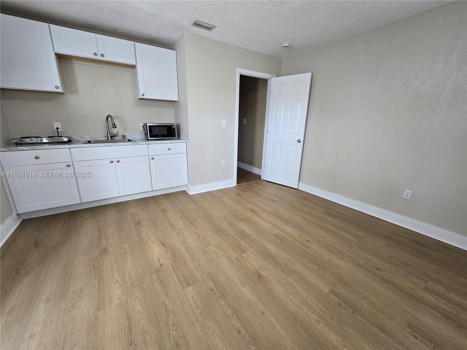 13340 Northeast 16th Avenue North Miami, FL 33161 - Photo 12 of 18 a very nice looking room with wooden floor